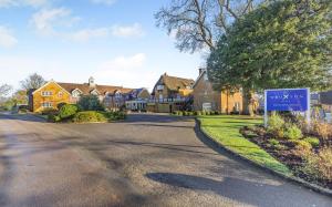 a house with a sign in the middle of a street at Banbury Wroxton House Hotel in Banbury