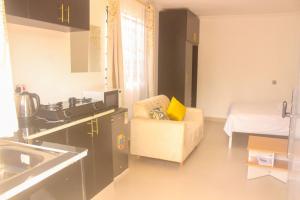 a living room with a couch and a bed at Miranda suites in Bungoma
