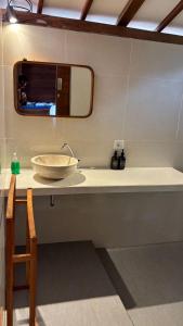 a bathroom with a bowl sink and a mirror at Castaway Island Hostel in Nusa Lembongan