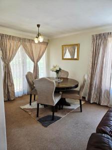 a dining room with a table and chairs at Hillcrest Cosy Cottage in Hillcrest
