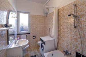 a bathroom with a white toilet and a sink at Casa Vacanze Belvedere in Santa Margherita Ligure