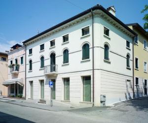 a large white building on the side of a street at Corte Trambai in Gambellara