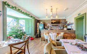 a dining room with tables and a christmas tree at Banbury Wroxton House Hotel in Banbury