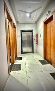 an empty hallway with a door and a tile floor at D S valley in Rishīkesh +12 photos