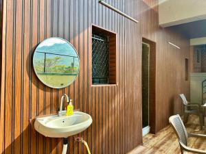 a bathroom with a sink and a mirror at Heaven-The Mannat Sanctuary in Lonavala