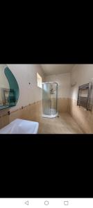 a bathroom with a shower and a white sink at Gabala villa in Gabala