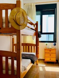 a bedroom with two bunk beds with a hat at Calamora I by Sun & Sea Homes in Moraira