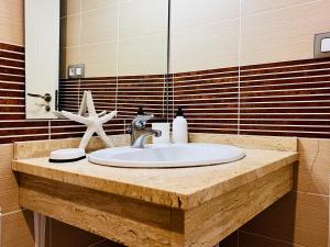 a bathroom sink with a starfish on top of it at Calamora I by Sun & Sea Homes in Moraira +7 photos