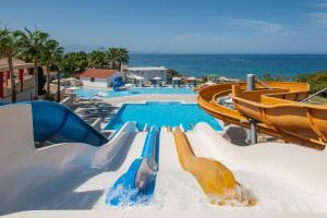 a water slide in a resort with a pool at Rethymno Mare Royal & Water Park in Skaleta +102 photos