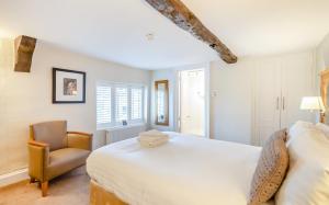 a bedroom with a bed and a chair at Banbury Wroxton House Hotel in Banbury +77 photos