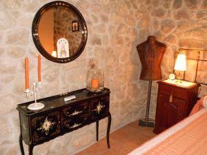 a bedroom with a dresser and a mirror on a wall at El Balcon de Los Sueños in Trevejo