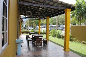 a patio with a table and chairs under a pergola at Homestay at 137 in Kuala Lumpur