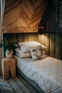 a bedroom with a bed with a wooden ceiling at Pokoje Gościnne u Moniki Zakopane in Zakopane