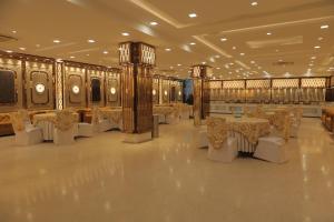 a banquet hall with tables and chairs in a building at GOLDEN TREE in Noida