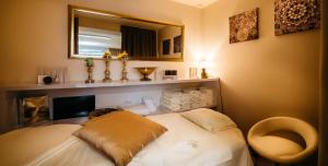a room with a bed with a mirror and a chair at Maximus Resort in Brno +21 photos
