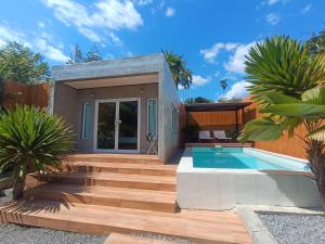 ein Haus mit einem Pool und einer Holztreppe in der Unterkunft Anita dream house in Khao Sok