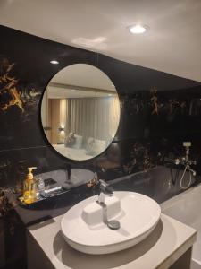 a bathroom with a sink and a mirror at hotel Sunrise Residency in Mumbai