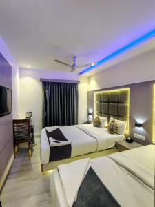 a hotel room with two beds and a television at hotel Sunrise Residency in Mumbai