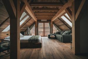 a bedroom with a bed and a couch in a room at Domačija Majer'ca in Bohinj
