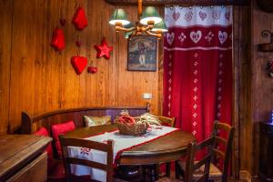 ein Esszimmer mit einem Tisch und einem roten Vorhang in der Unterkunft tHE Courmaison - Courmayeur in Courmayeur + 19 Fotos