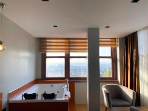 una camera con una grande finestra con un divano e una sedia di Elite Marmara Bosphorus Çamlıca a Istanbul