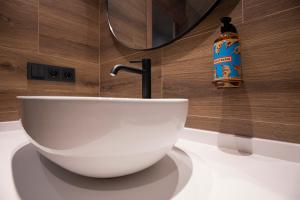 a bathroom with a white bowl sink on a counter at Hotel del Tarter in El Tarter +65 photos