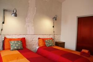 two beds sitting next to each other in a room at B&B Loft Padova in Padova +15 photos