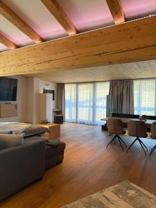 a large living room with a couch and a tv at Panorama Quartier Seefeld in Seefeld in Tirol