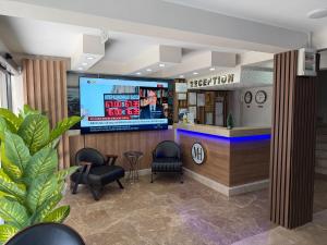 a waiting room with two chairs and a television at Metrohill Hotel in Istanbul