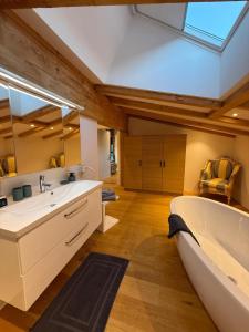 a large bathroom with a tub and a sink at Panorama Quartier Seefeld in Seefeld in Tirol