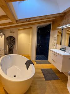 a large bathroom with a large tub and a sink at Panorama Quartier Seefeld in Seefeld in Tirol +66 photos