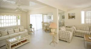 a living room with a couch and a table at Mango Court 1 - by ZenBreak in Saint James