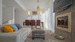 a living room with a couch and a fireplace at Chambres Mountain in Poiana Brasov