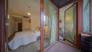 a bedroom with a bed and a sliding glass door at Chambres Mountain in Poiana Brasov +54 photos