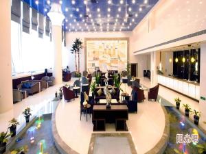 a lobby with a table and chairs in a building at Ramada Plaza Shenyang Citycenter in Shenyang