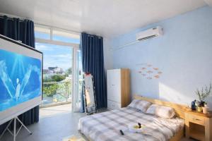 a bedroom with a bed and a large screen tv at Cozynest Homestay n Cinema in Ho Chi Minh City