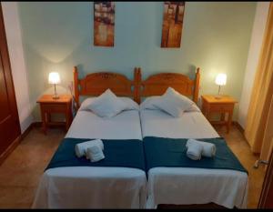 a bedroom with a large bed with two pillows at Portal 17 Can Tort in Tossa de Mar +38 photos