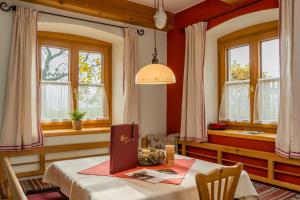 a dining room with a table and windows at Vitalhof Roithinger in Grieskirchen