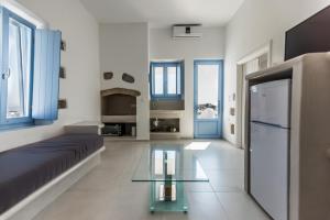 a living room with a couch and a glass table at Plaka Suites in Plaka Milou