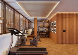 a room with a gym with a treadmill and a room with wine bottles at Palacio San Juan, a Royal Hideaway Hotel in Murcia