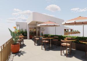 a patio with tables and chairs and umbrellas at Palacio San Juan, a Royal Hideaway Hotel in Murcia