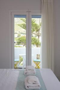 a bedroom with a bed and a window with a view at Irene Studios in Agios Petros