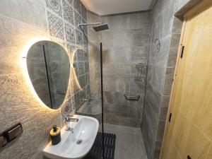 a bathroom with a sink and a mirror at Agadir Gardens Center Hotel in Agadir