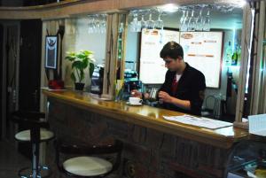 a man sitting at a counter in a bar at Apartment Roman in Lviv