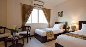 Postel nebo postele na pokoji v ubytování Lao Golden Hotel + 212 fotografií