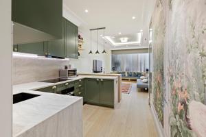 a kitchen with green cabinets and a living room at 1 Bed Flat in London in London