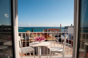 a view of a balcony with a table and chairs at ΛΙΜΑΝΙ in Chios
