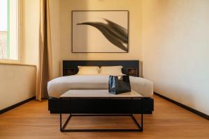 a bedroom with a bed with a table in it at Cavour Suites in Ancona
