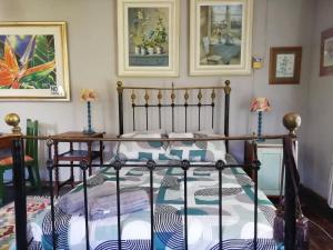 a bedroom with a bed with a metal frame at Cottage on Roux in Smithfield