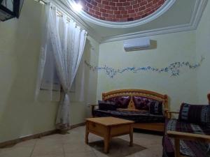 a living room with a couch and a table at Résidence SUN SHINE DJERBA in Midoun